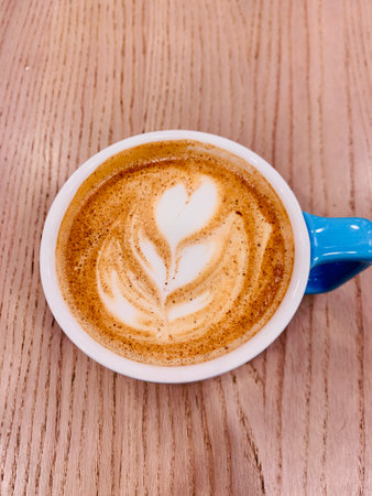 cappuccino cup blue on the brown wooden tableの写真素材