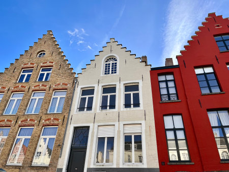 Bruges, Belgium - October 22, 2022: The upper part of the front facade of a historic brick house. This house is among other housesの写真素材