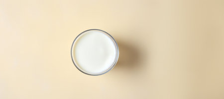 Glass of milk on the beige background. Top view.の素材