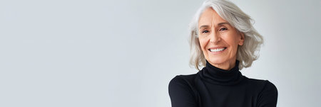 Positive gray haired senior woman standing with arms crossed over white background, empty space, panoramic banner.の素材
