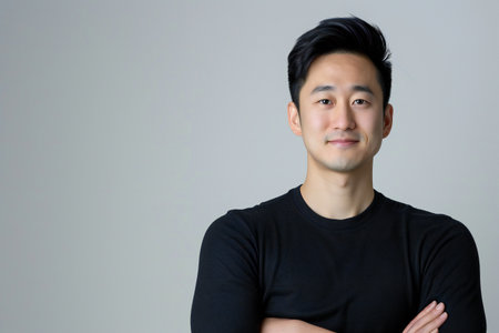 portrait asian man cross arm smile on isolated background in studioの素材
