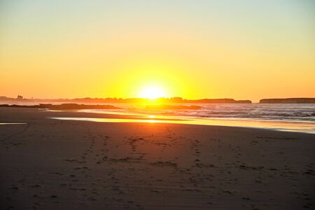 Sunset over the sea along the coastの写真素材