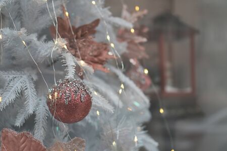 Delicate pink shiny decor on a white Christmas tree.の写真素材