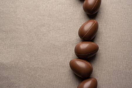 Chocolate easter eggs on the linen beige tableclothの写真素材