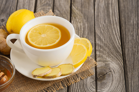Chamomile tea with lemon, ginger and honey on the rustic wooden tableの写真素材