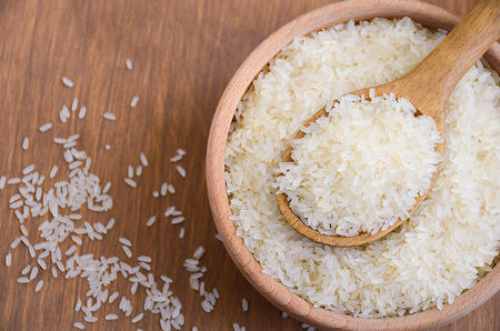 Raw basmati rice in a wooden bowl. Horizontal permission. Top view.の写真素材