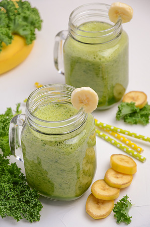 Fresh smoothie with kale and banana on white background, selective focusの写真素材