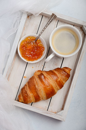 Cup of fresh morning coffee with croissant. Valentine's day concept.の写真素材