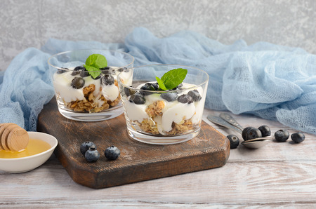 Healthy dessert with homemade granola, yogurt and blueberries, selective focus, copy spaceの写真素材