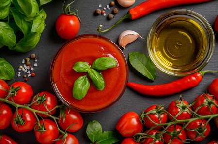 Tomato sauce with ingredients on black backgroundの写真素材