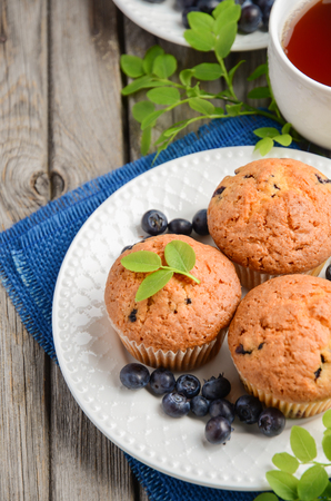 Homemade blueberry muffins on rustic wooden background, selective focusの写真素材