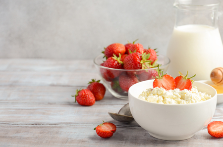Fresh cottage cheese with fresh strawberries, healthy breakfast concept, selective focusの写真素材