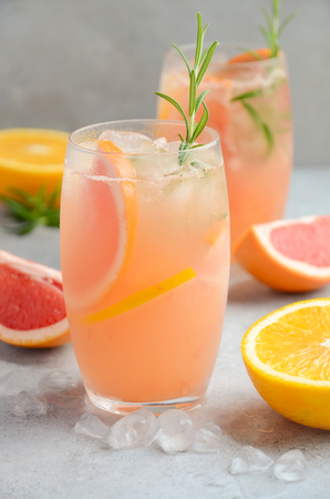 Refreshing citrus cocktail with grapefruit, orange and rosemaryの写真素材