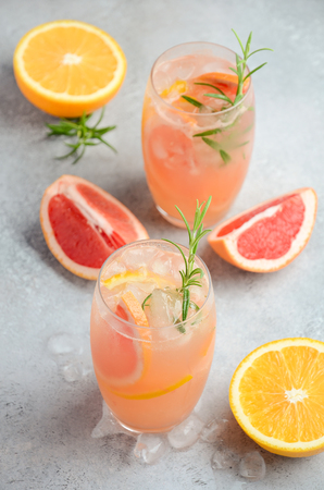 Refreshing citrus cocktail with grapefruit, orange and rosemaryの写真素材