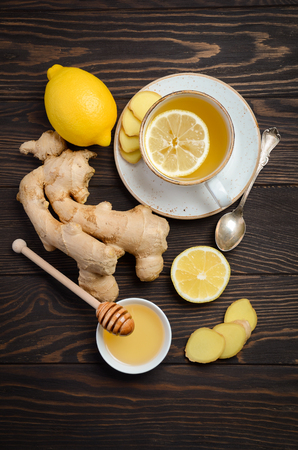 Ginger root tea with lemon and honey on a wooden backgroundの写真素材
