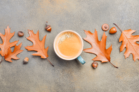 Autumn Composition with Cup of Coffee and Autumn Leaves on Stone or Concrete Backgroundの写真素材