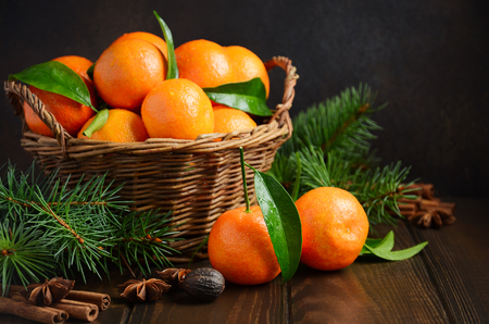 Fresh tangerine clementines with spices on a dark wooden background, Christmas concept.の写真素材