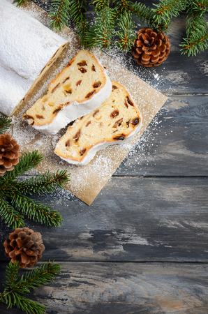 Christmas Stollen. Traditional German, European Festive Dessert. Holiday Concept Decorated with Fir Branches. Top View Flat Lay Copy Space.の写真素材