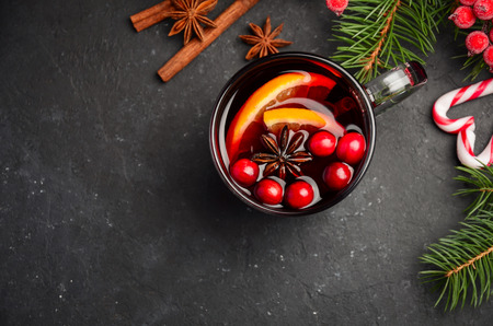 Christmas Mulled Wine with Orange and Cranberries. Holiday Concept Decorated with Fir Branches and Spices.の写真素材