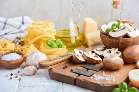 Ingredients for making tagliatelle pasta with mushrooms. Healthy Italian food. Selective focus.の写真素材