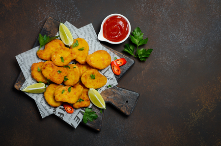 Crispy Fried Chicken Nuggets with Tomato Sauce on Dark Background Top View Flat Lay Copy spaceの写真素材