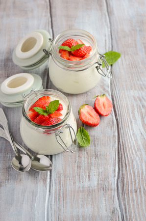 Homemade natural yogurt with strawberries and mint, selective focus, copy space.の写真素材