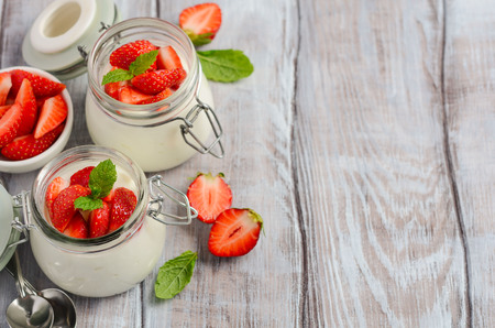 Homemade natural yogurt with strawberries and mint, selective focus, copy space.の写真素材