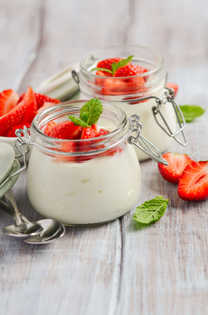 Homemade natural yogurt with strawberries and mint, selective focus.の写真素材