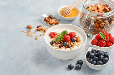 Homemade granola with yogurt and fresh berries, healthy breakfast concept, selective focus, copy space.の写真素材
