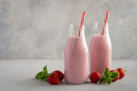 Strawberry milkshake on a gray concrete background, selective focus.の写真素材