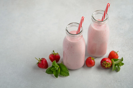 Strawberry milkshake on a gray concrete background, selective focus.の写真素材