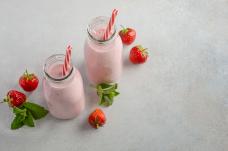 Strawberry milkshake on a gray concrete background, selective focus.の写真素材