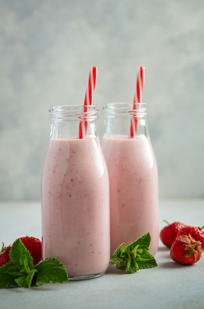 Strawberry milkshake on a gray concrete background, selective focus.の写真素材