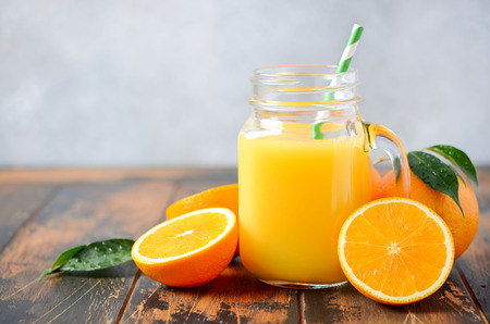 Fresh orange juice on a wooden table.の写真素材