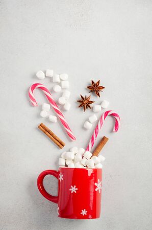 New Year or Christmas concept. Composition with marshmallows and candy canes on a gray concrete background. Top view, flat lay, copy space.の写真素材