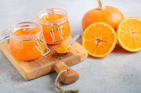 Homemade pumpkin and orange confiture in a jars on a gray concrete background.の写真素材