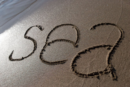 The inscription on the sand at the edge of the sea