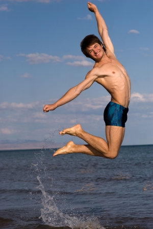 Nice jump over the summer seaの写真素材