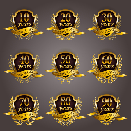 Set of gold anniversary badges with laurel wreaths, shield, numbers. Decorative emblem of jubilee on gray background. Filigree element, frame, border, icon, logo for web, page design in vintage styleのイラスト素材