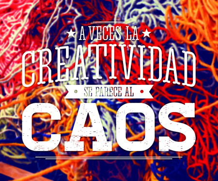 A veces la Creatividad se parece al Caos - Creativity sometimes looks like Chaos spanish text, quote on a blurred abstract background of multicolored woolの写真素材