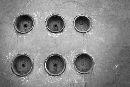 Line up of six electric power meters on vintage wall, black and white sceneの写真素材