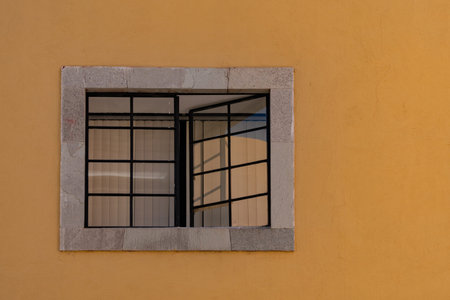 Mexican classic colonial style window with yellow wall in Guanajato Mexico
