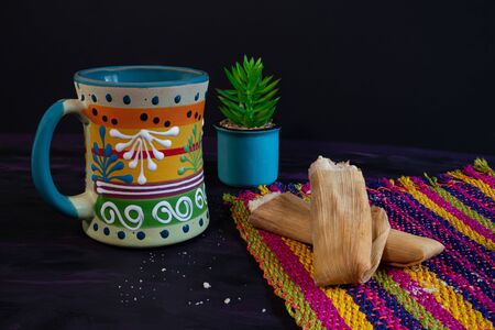 Tamales Mexican dish made of Corn dough and Coffee Jar on Woven Tablecloth.の写真素材