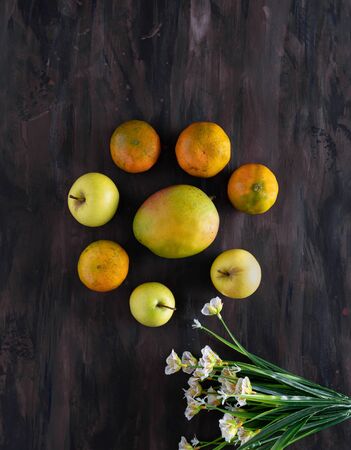 Tangerines, Apples and Mango Fresh Fruit on Hand Painted Canvas.の写真素材