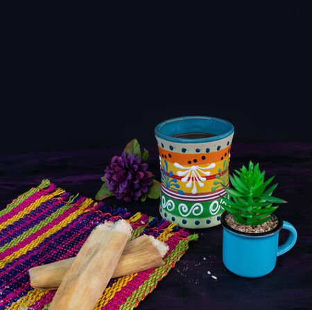 Tamales Mexican dish made of Corn dough and Coffee Jar on Woven Tablecloth.の写真素材
