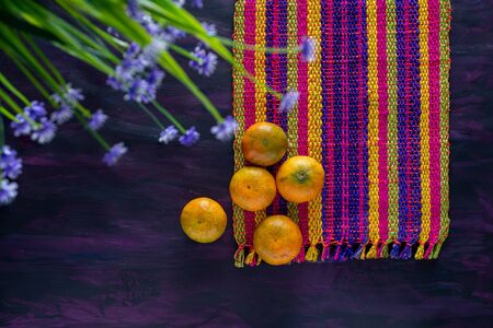 Mandarin Orange Tangerines Fresh Fruit on Woven Tablecloth.の写真素材