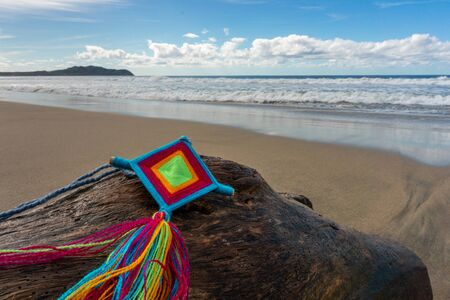 Mandala Eye of God Mexican Huichol Crafts on trunk in Sayulita beach.の写真素材