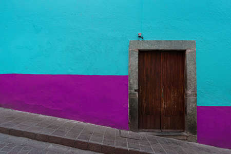 Colonial style wooden Door with colorful walls in Guanajuato Mexico.の写真素材
