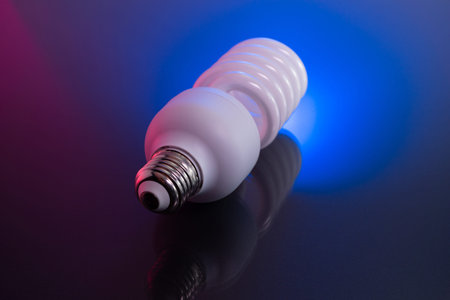 Energy Saving Lamp on colorful gloss background.の写真素材