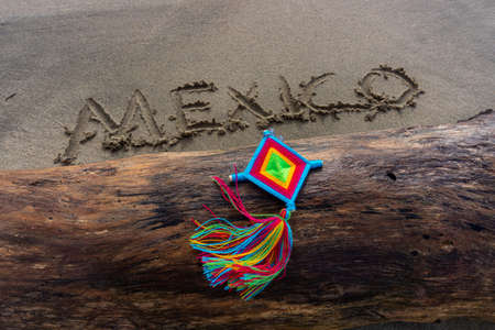 Mandala Eye of God Mexico Huichol Crafts on trunk in Sayulita beach.の写真素材